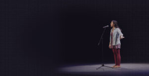 woman on stage at mic